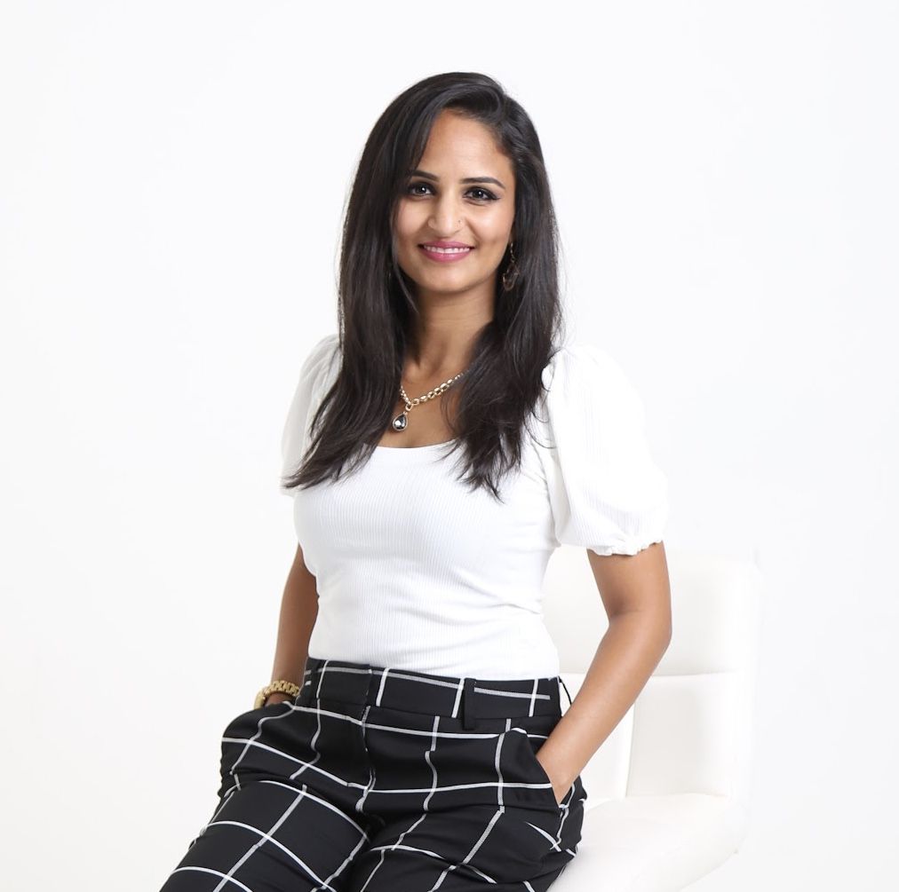 Taniya Refai seated in a white top